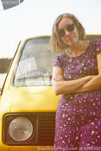 Image of Dreaming girl leaning on van