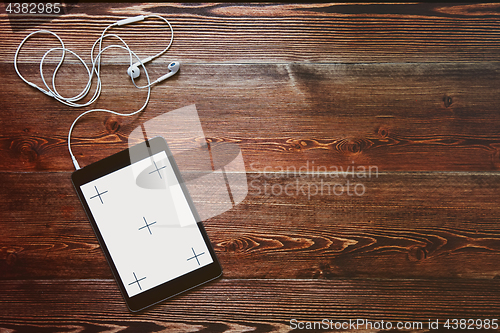 Image of Digital tablet computeron old wooden desk.