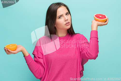 Image of Beautiful woman\'s face with juicy orange