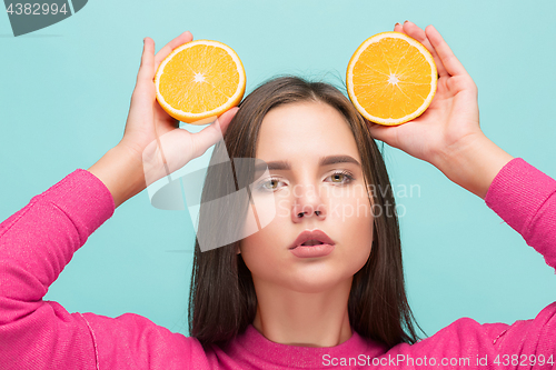 Image of Beautiful woman\'s face with juicy orange