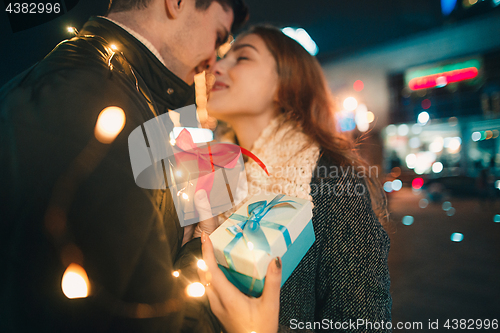 Image of romantic surprise for Christmas, woman receives a gift from her boyfriend