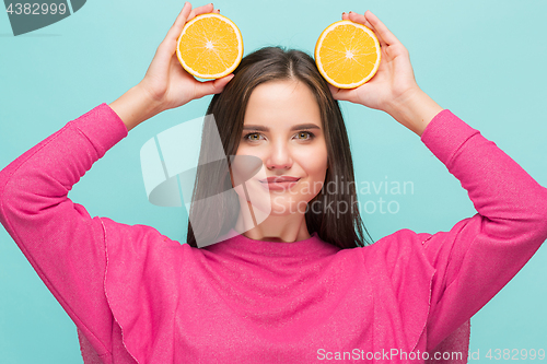 Image of Beautiful woman\'s face with juicy orange
