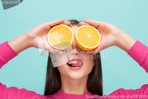 Image of Beautiful woman\'s face with juicy orange
