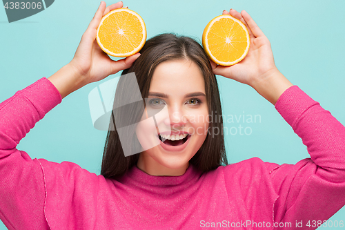 Image of Beautiful woman\'s face with juicy orange