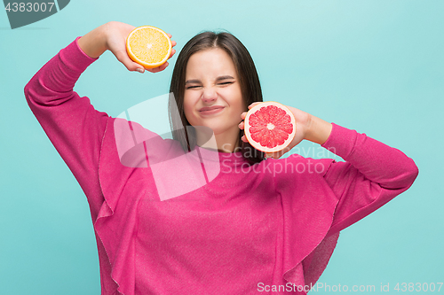 Image of Beautiful woman\'s face with juicy orange