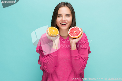 Image of Beautiful woman\'s face with juicy orange