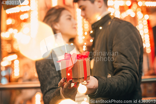 Image of romantic surprise for Christmas, woman receives a gift from her boyfriend