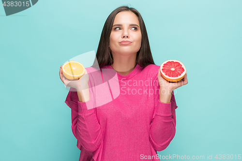 Image of Beautiful woman\'s face with juicy orange