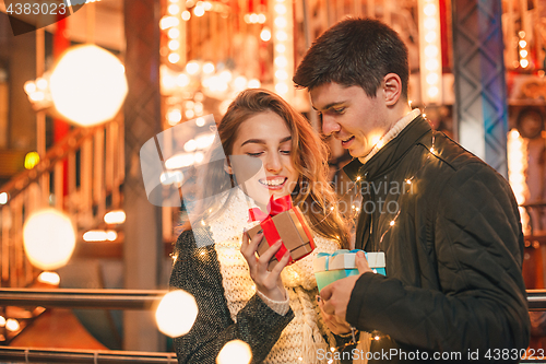 Image of romantic surprise for Christmas, woman receives a gift from her boyfriend