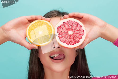 Image of Beautiful woman\'s face with juicy orange