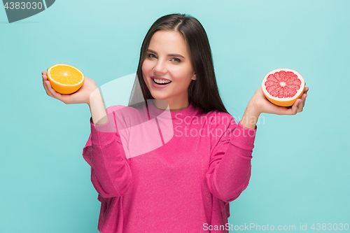 Image of Beautiful woman\'s face with juicy orange