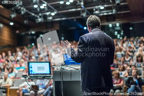 Image of Public speaker giving talk at Business Event.