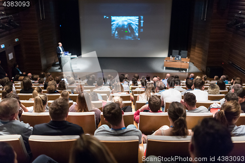 Image of Speaker giving presentation on health care conference.