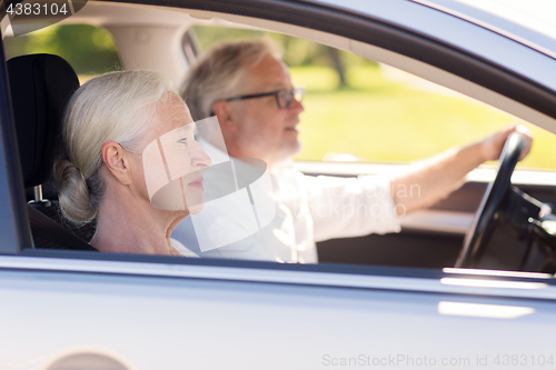 Image of happy senior couple driving in car