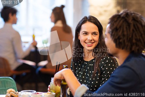 Image of happy couple with drinks at restaurant or bar
