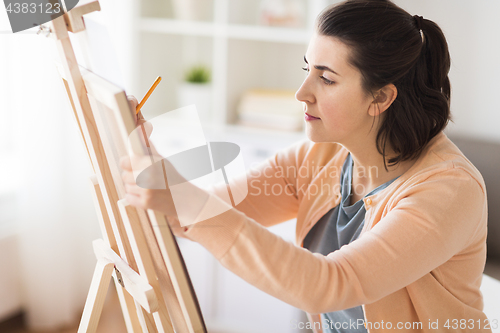 Image of artist with pencil drawing picture at art studio