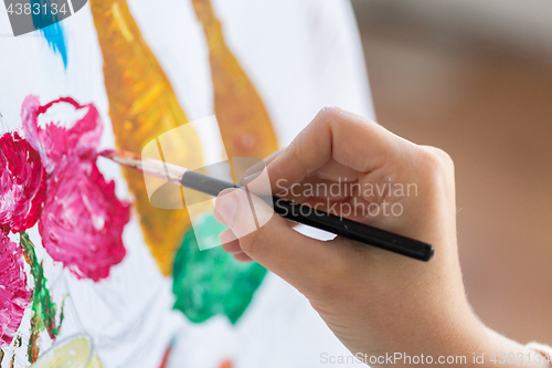 Image of artist with brush painting still life picture