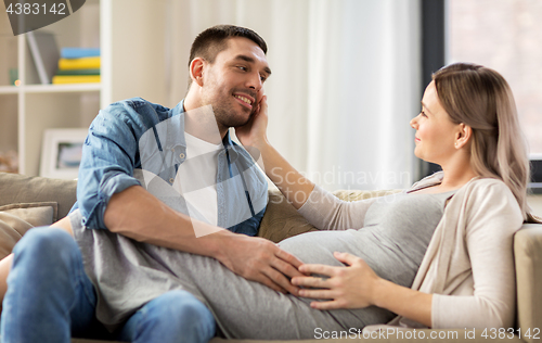 Image of happy man with pregnant woman at home