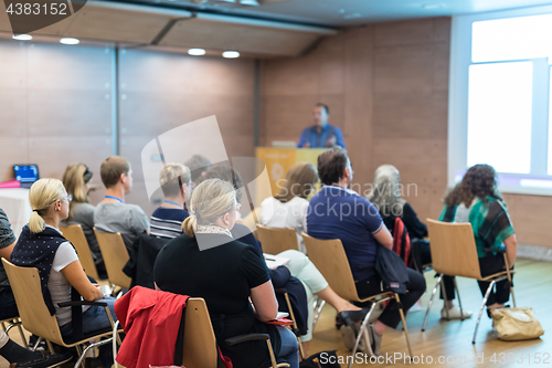 Image of Speaker giving presentation on health care conference.