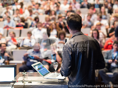 Image of Public speaker giving talk at Business Event.