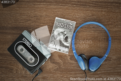 Image of Vintage walkman, the prodigy cassete and headphones.