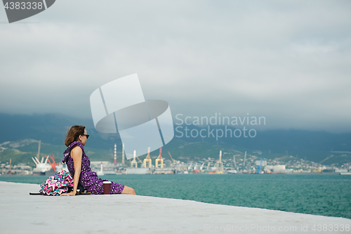 Image of Woman enjoying seascape on waterfront