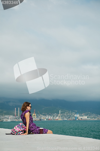 Image of Woman enjoying seascape on waterfront