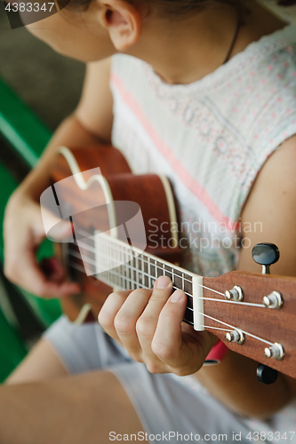 Image of Anonymous woman playing ukulele