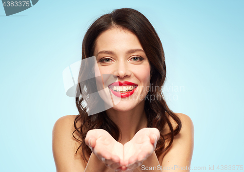 Image of beautiful smiling young woman with red lipstick