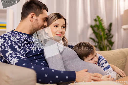 Image of happy family with pregnant mother at home