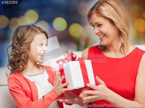 Image of happy mother and daughter with gift box