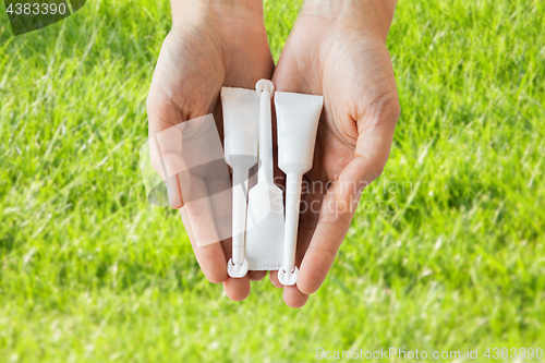 Image of hand holding tubes of micro enema