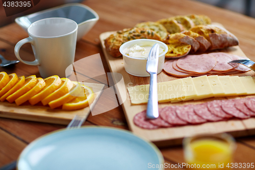 Image of cream cheese and other food on table at breakfast