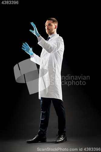 Image of doctor or scientist in lab coat and medical gloves