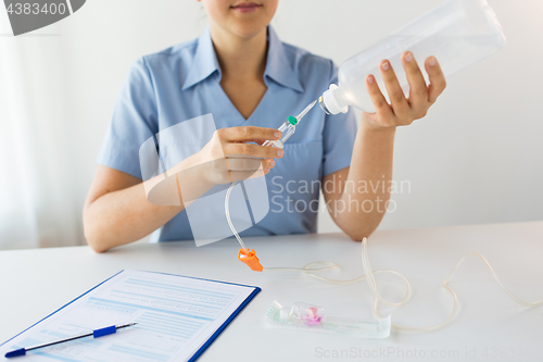 Image of close up of nurse preparing drop counter