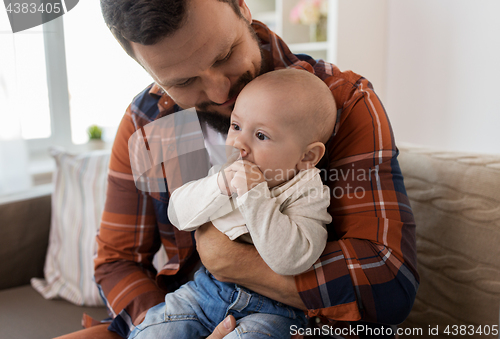 Image of close up of happy father with little baby at home