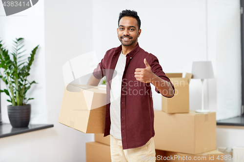 Image of man with box moving to new home showing thumbs up