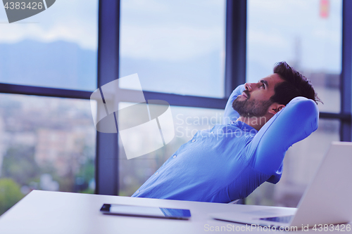 Image of happy young business man at office