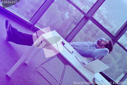 Image of happy young business man at office