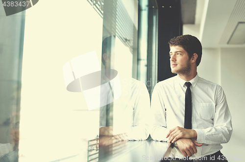 Image of happy young business man at office