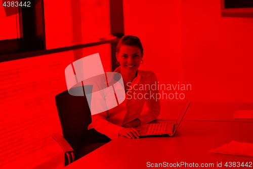 Image of Young pretty business woman with notebook in the office