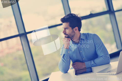 Image of happy young business man at office