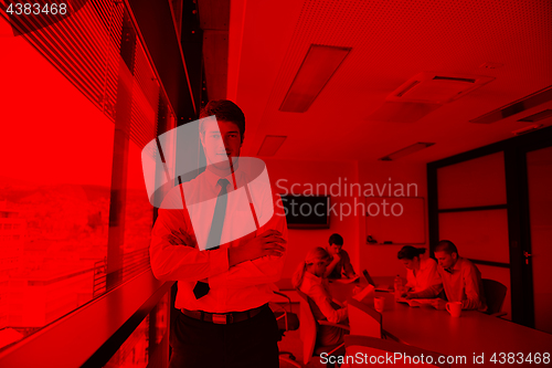 Image of business man  on a meeting in offce with colleagues in backgroun