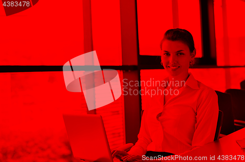 Image of Young pretty business woman with notebook in the office