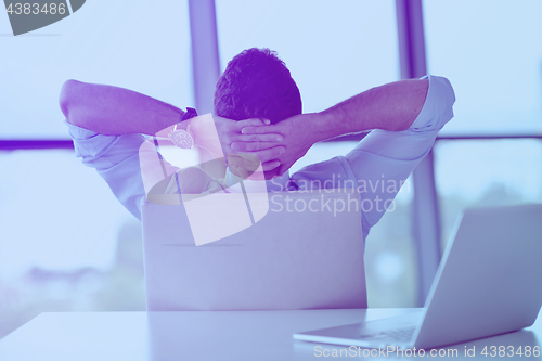 Image of happy young business man at office