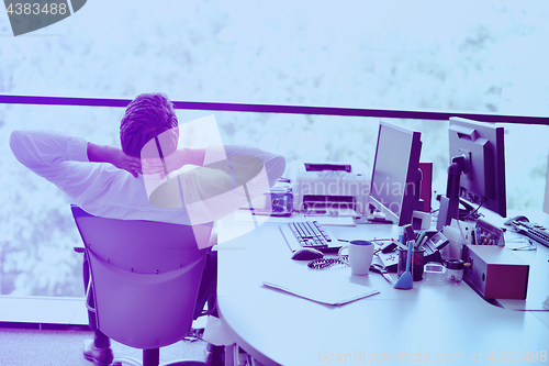 Image of happy young business man at office