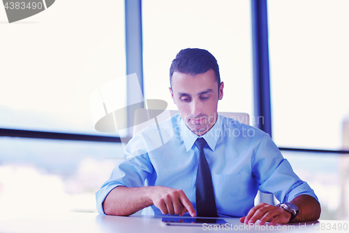 Image of business man using tablet compuer at office