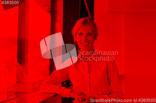 Image of business woman with her staff in background at office