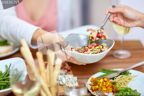 Image of people eating salad at table with food