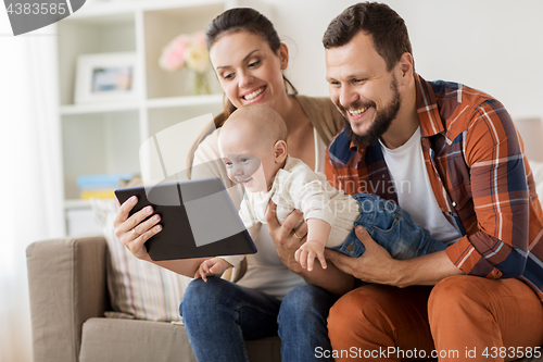 Image of mother, father and baby with tablet pc at home